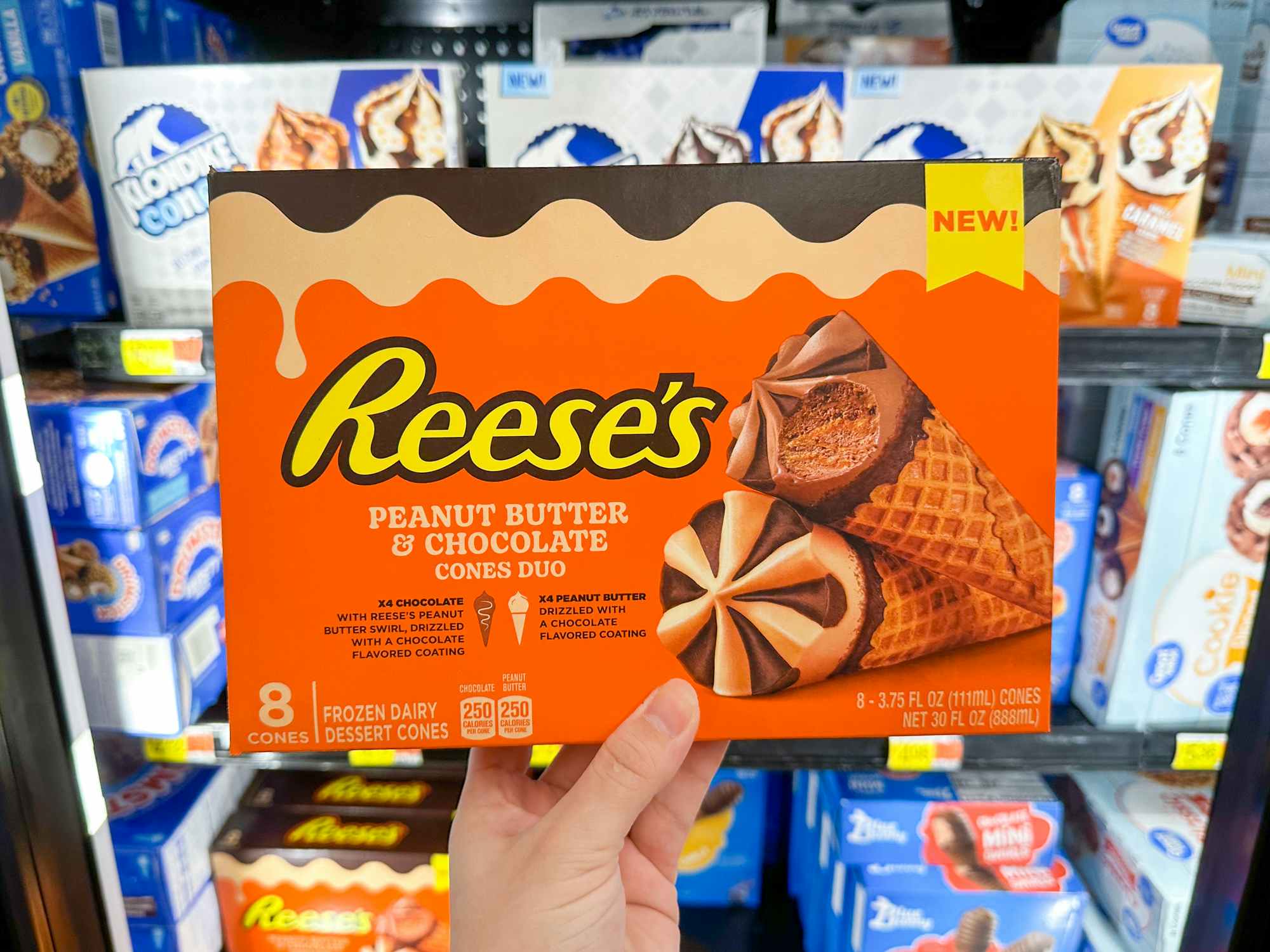 Someone holding a box of Reese's Peanut Butter Chocolate ice cream cones