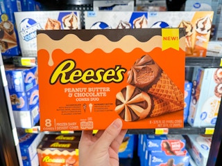 Someone holding a box of Reese's Peanut Butter Chocolate ice cream cones
