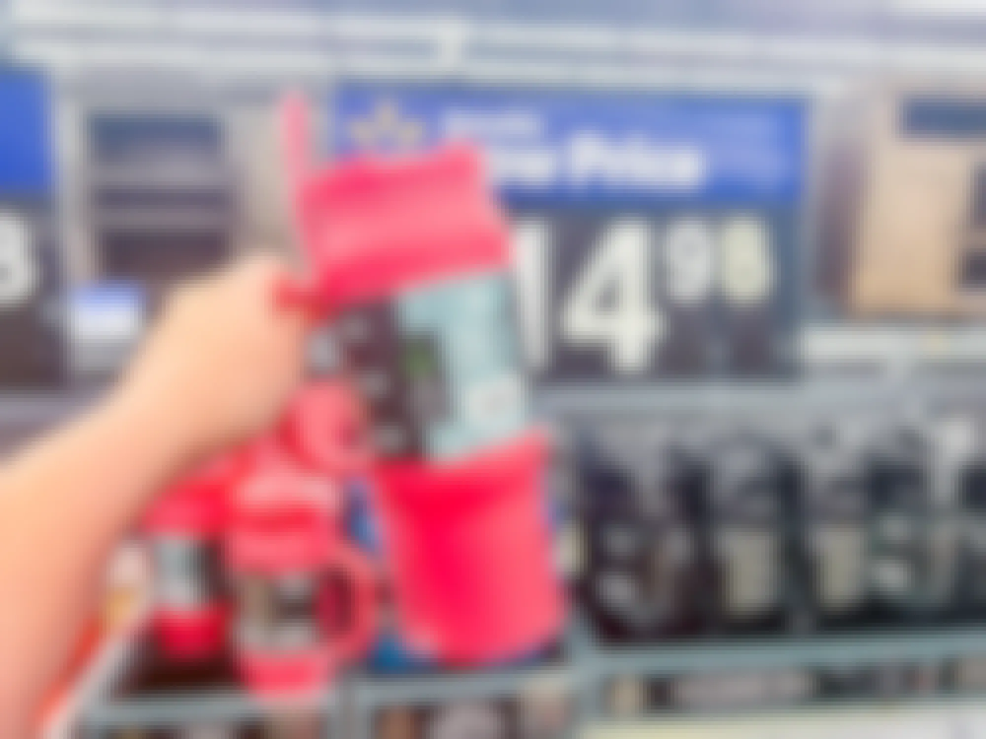 a person holding a pink cup at walmart