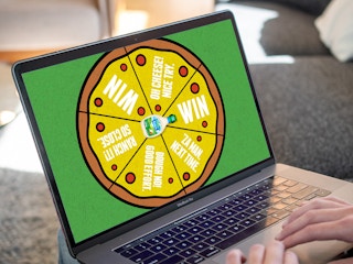 person playing a spin-to-win game for hidden valley ranch and marketplace pizza on laptop