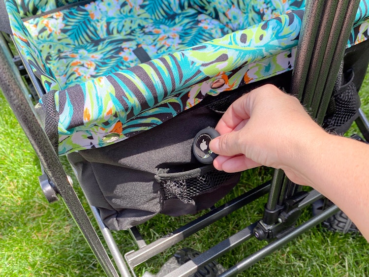 person placing an apple airtag into a wagon pocket