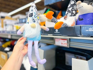 hand holding a stuffed gnome