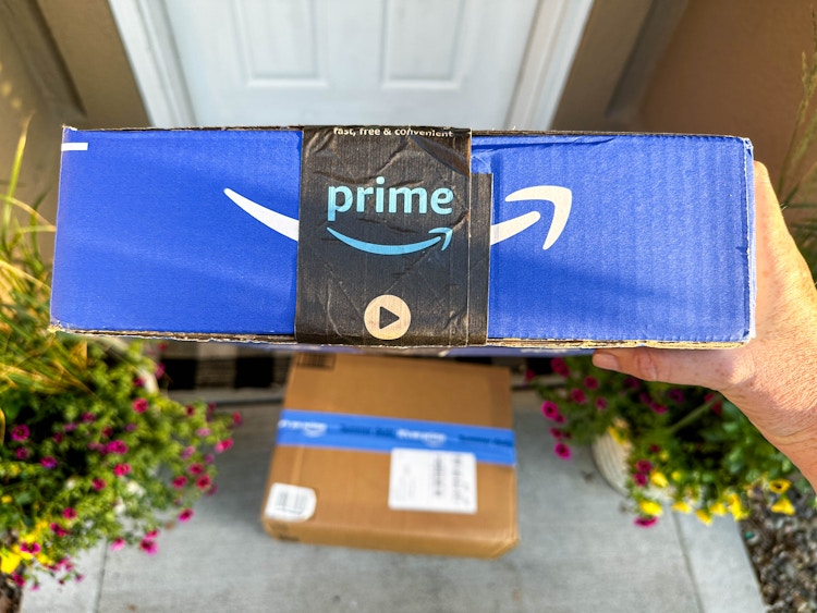an amazon box being held 
