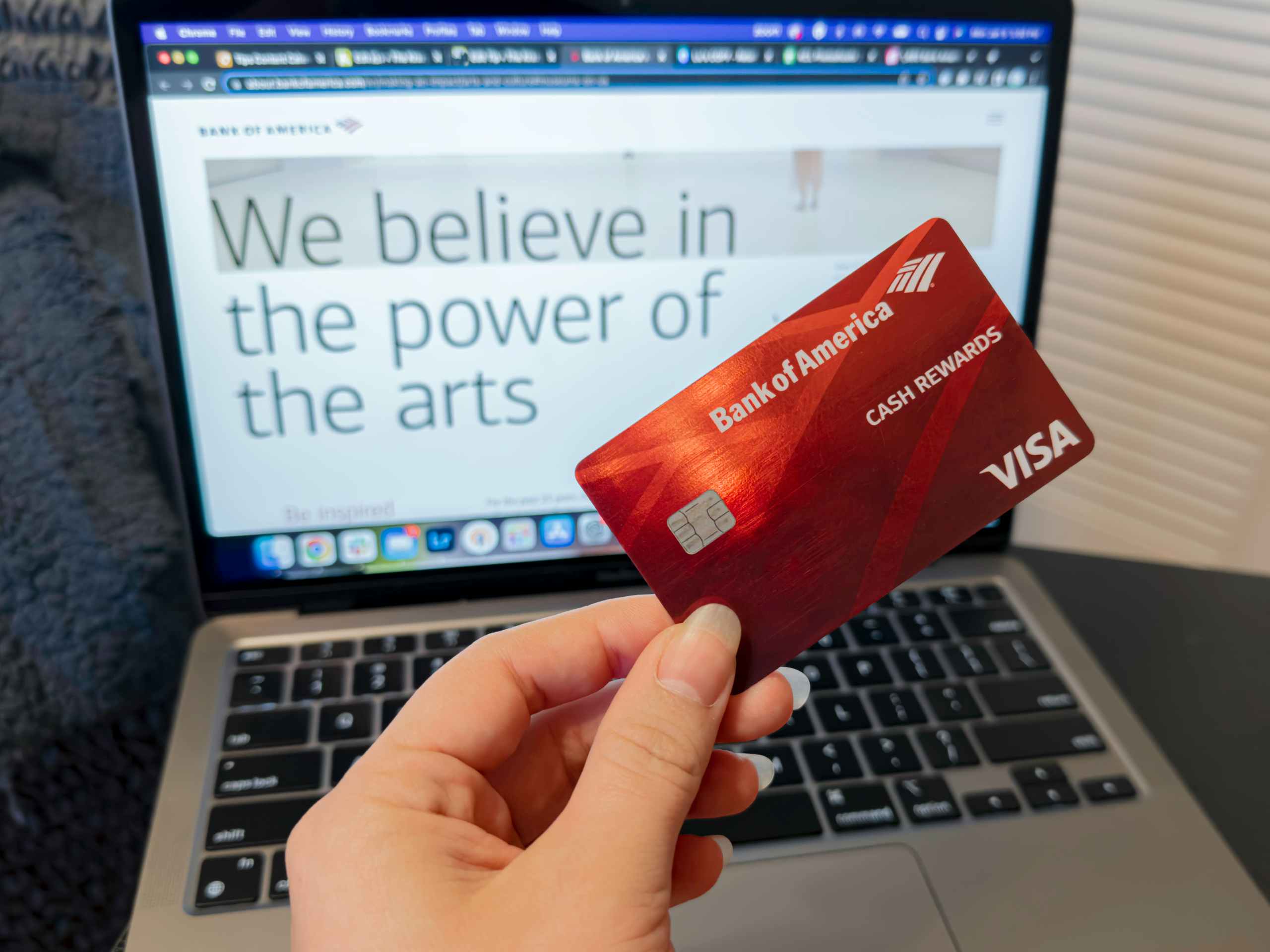 Hand holding a Bank of America Card