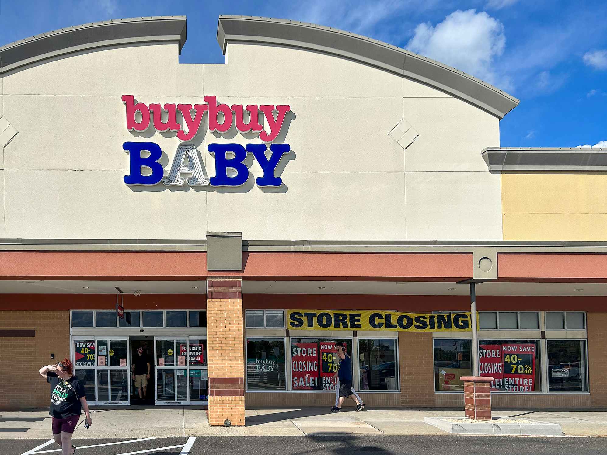 A buybuy Baby store front with people coming in and out