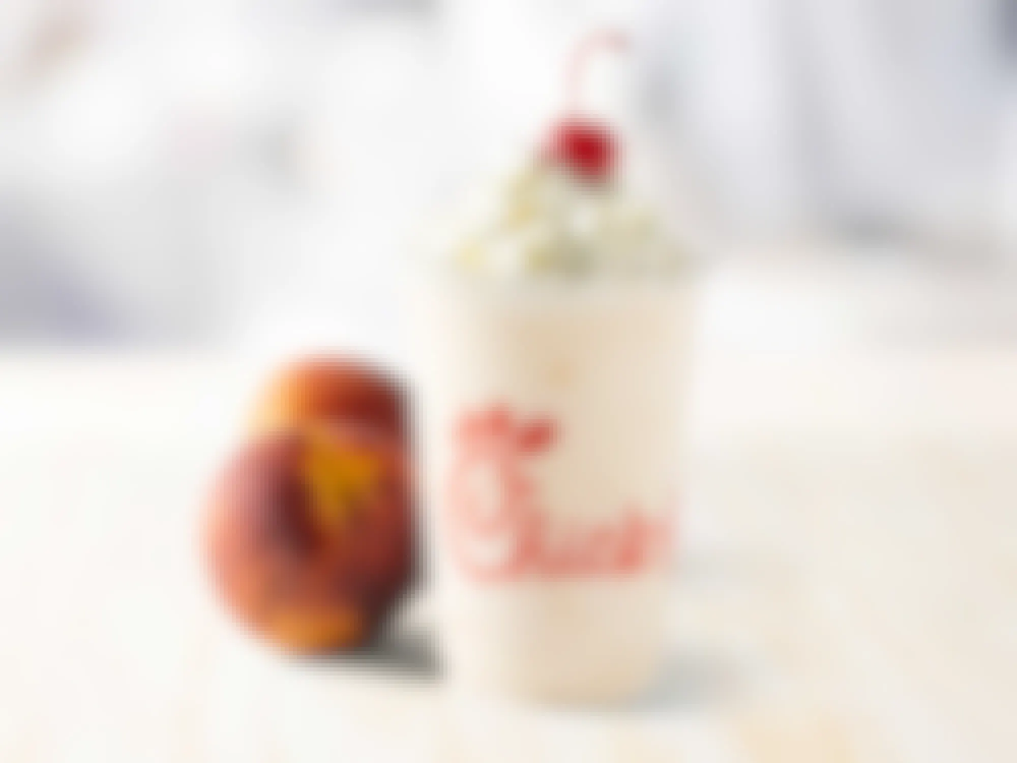 Chick-fil-A peach milkshake and peaches on a table