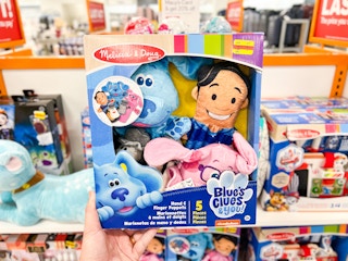 someone holding a blues clues toy