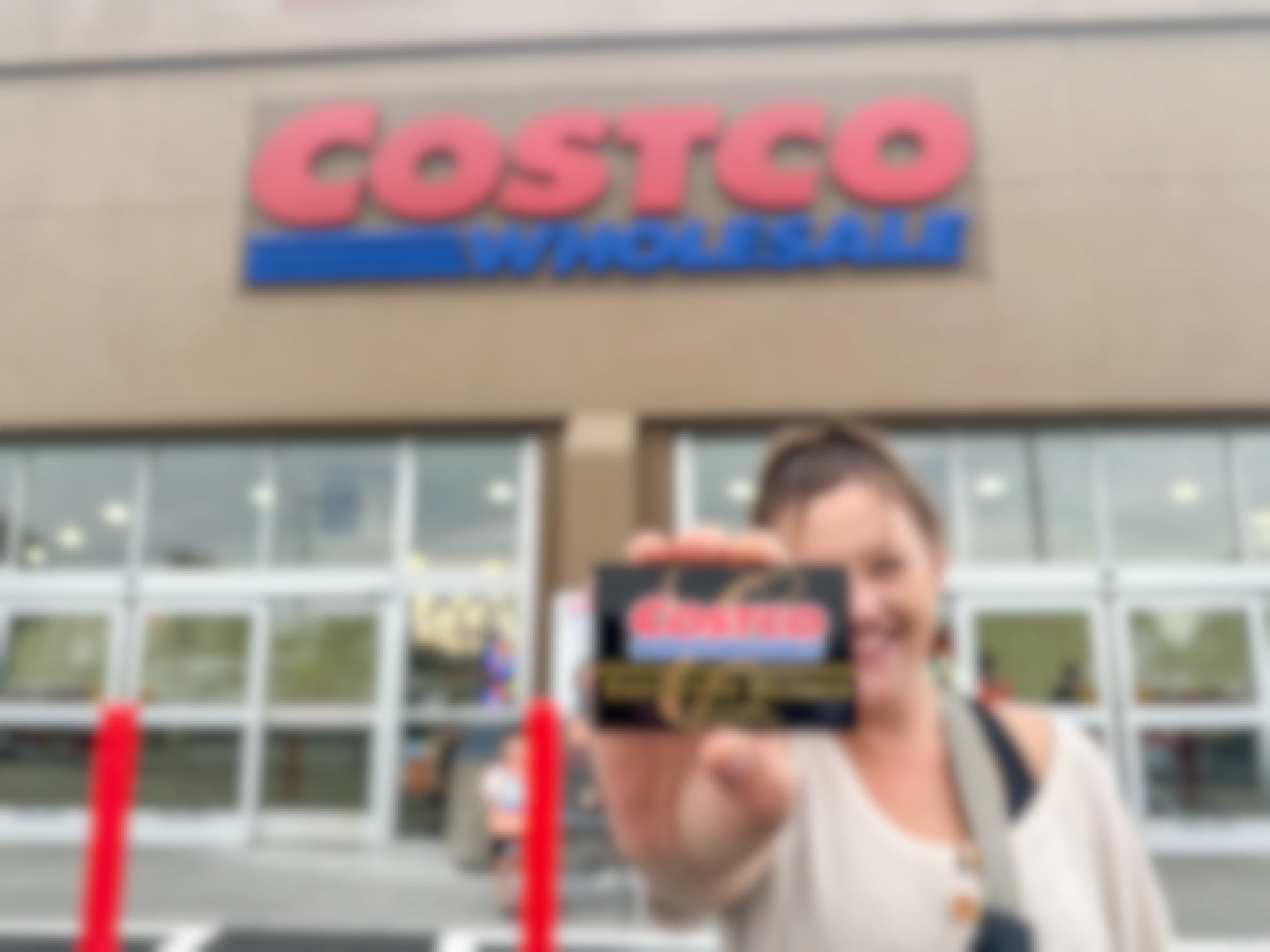 a person holding up a costco shopping card