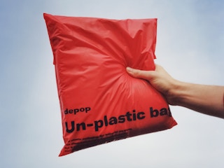 Someone holding up a Depop package