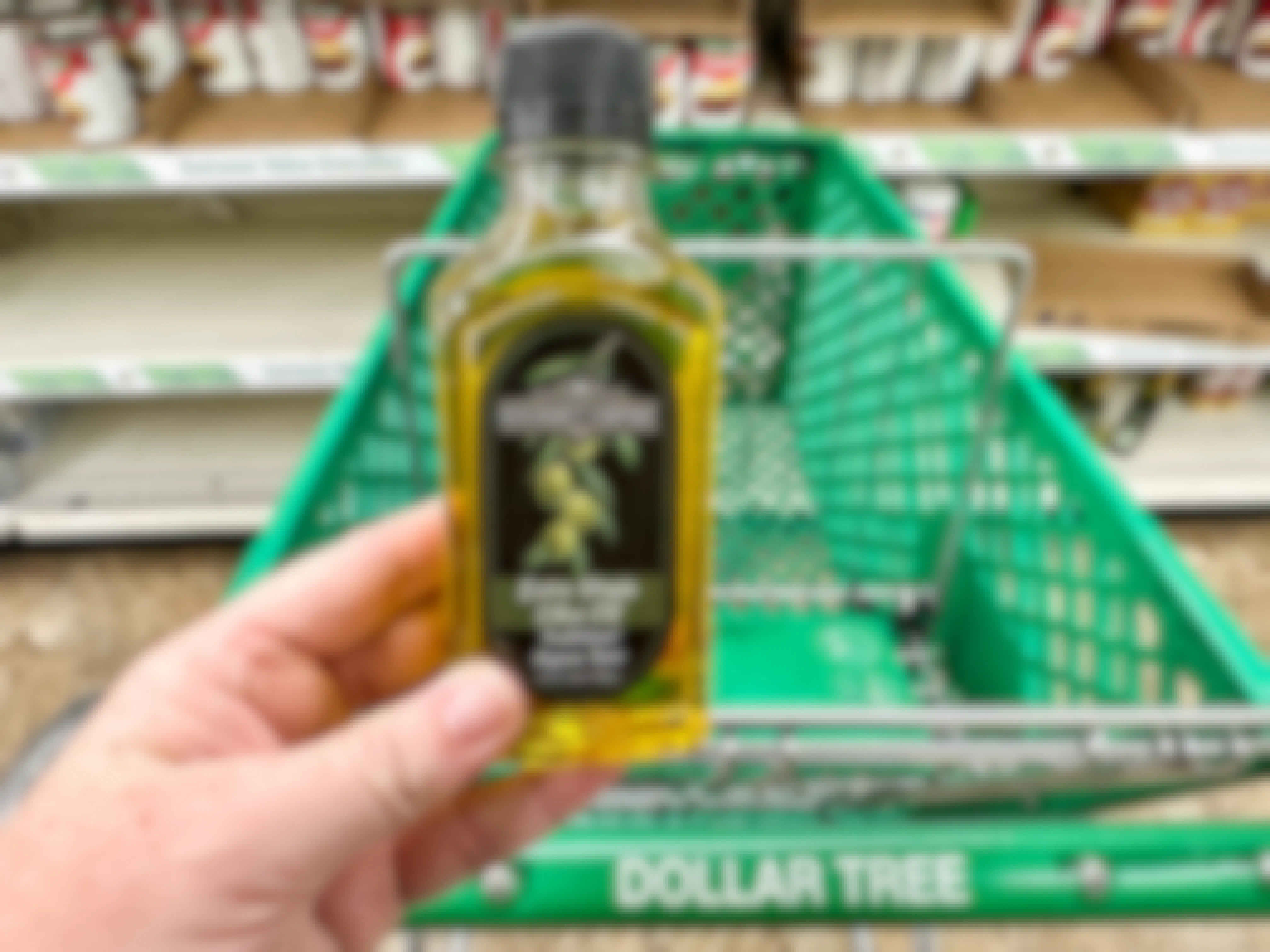 a container of olive oil next to a dollar tree cart 