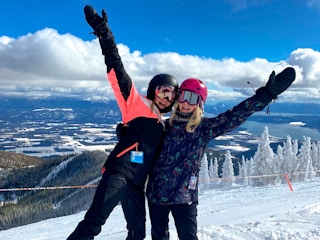 Two people having fun at a skiing location