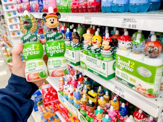 a person holding up two good2grow drinks