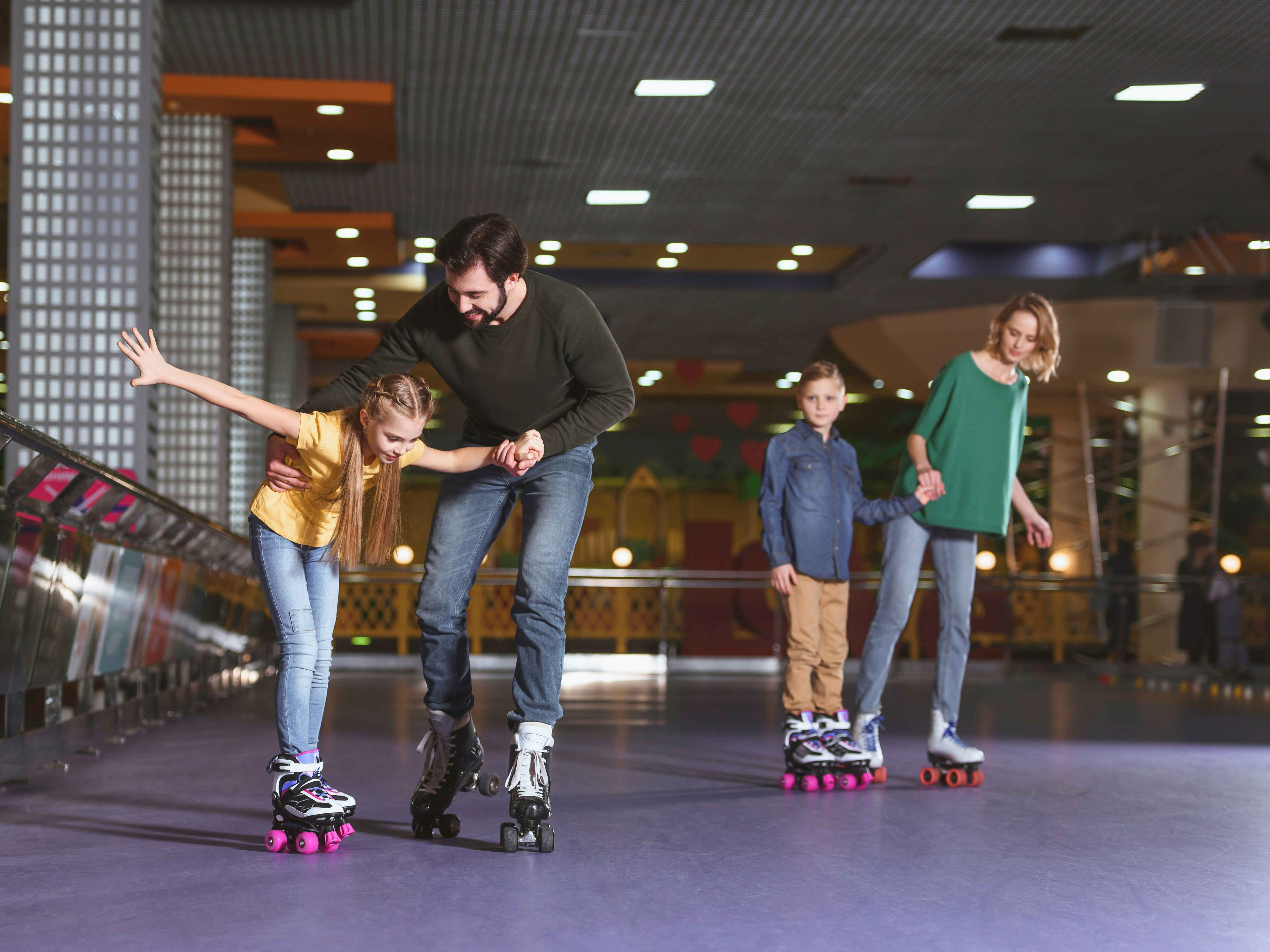 children and their parents rollerskating 