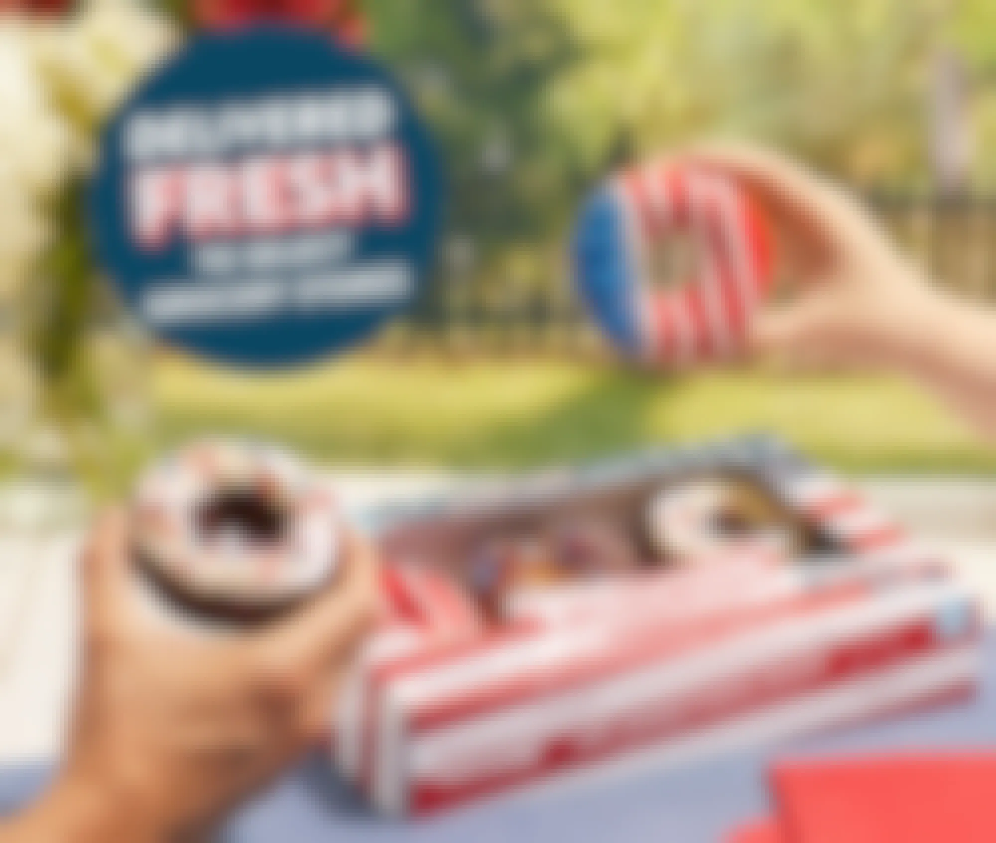 People holding up Red, White, and Blue themed doughnuts from Krispy Kreme's grocery store pack of patriotic doughnuts