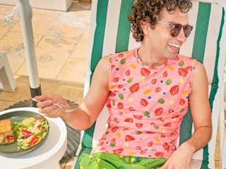 a person smiling while eating a salad from Panera