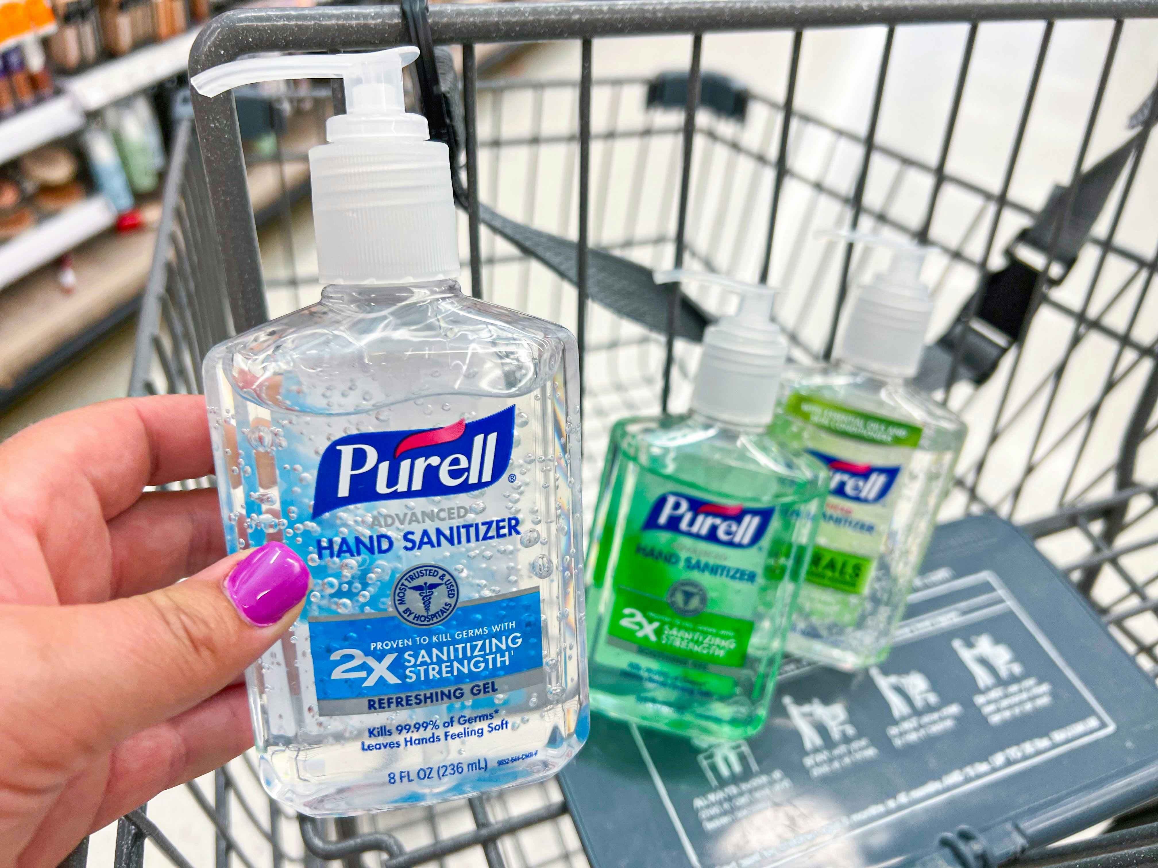 hand holding purell hand sanitizer