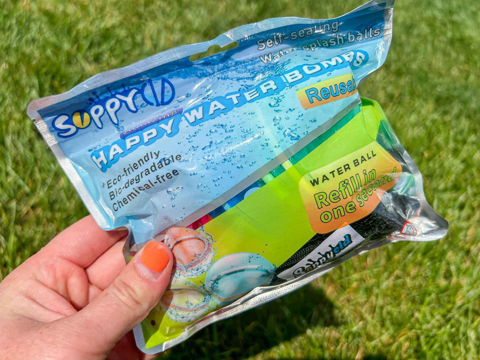 a person holding a pack of reusable water balloons