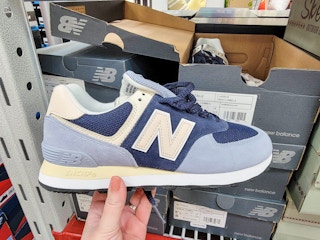 hand holding a new balance sneaker