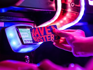 person scanning their dave and busters power card at the arcade