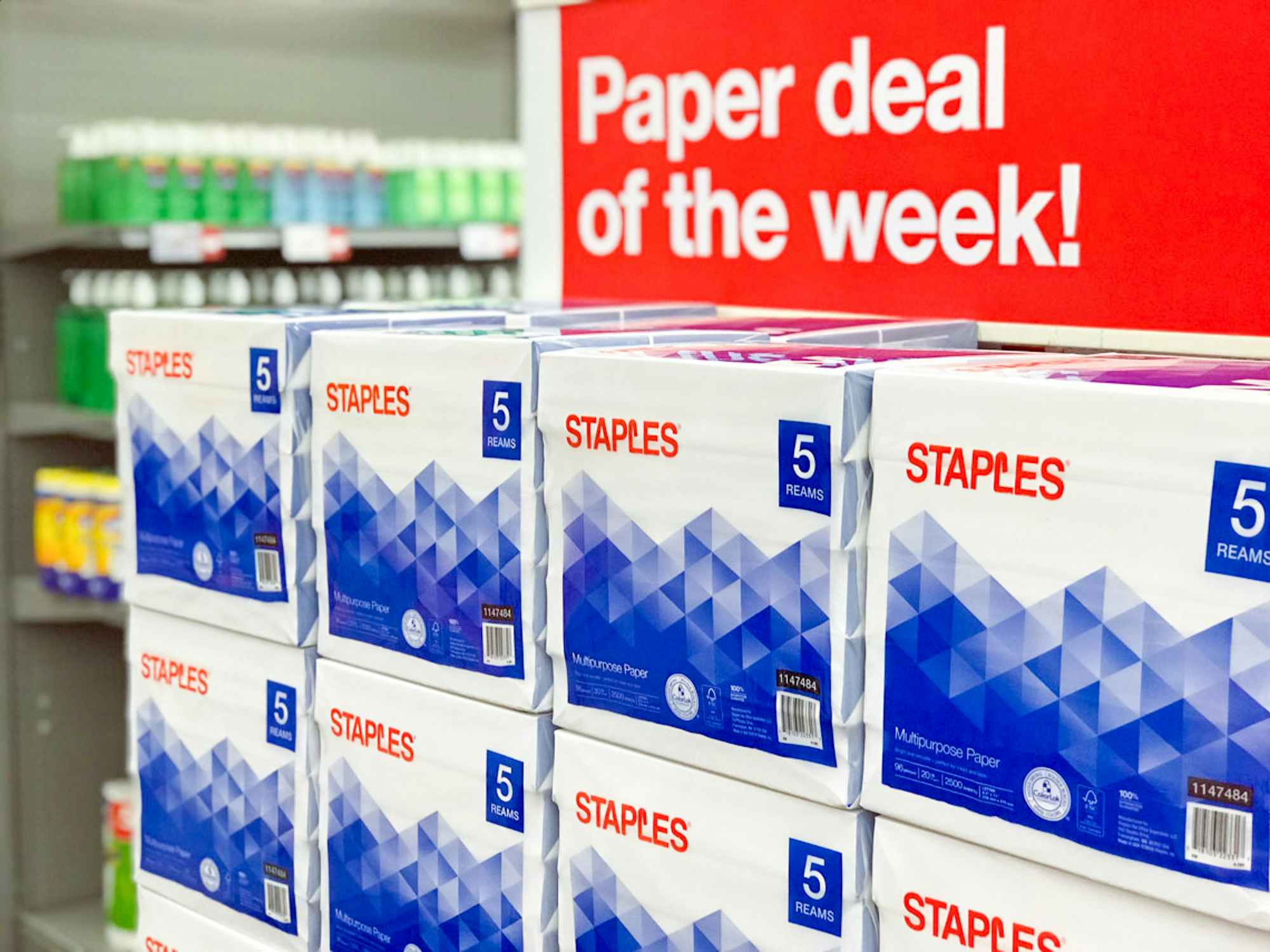 Reams of paper stocked at Staples with a sign that reads "Paper deal of the week