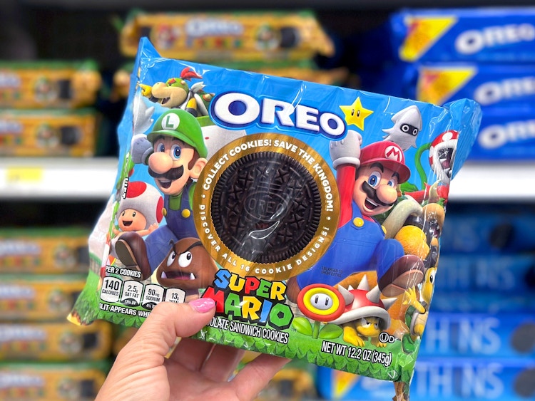 person's hand holding a package of super mario brothers oreo cookies in target store