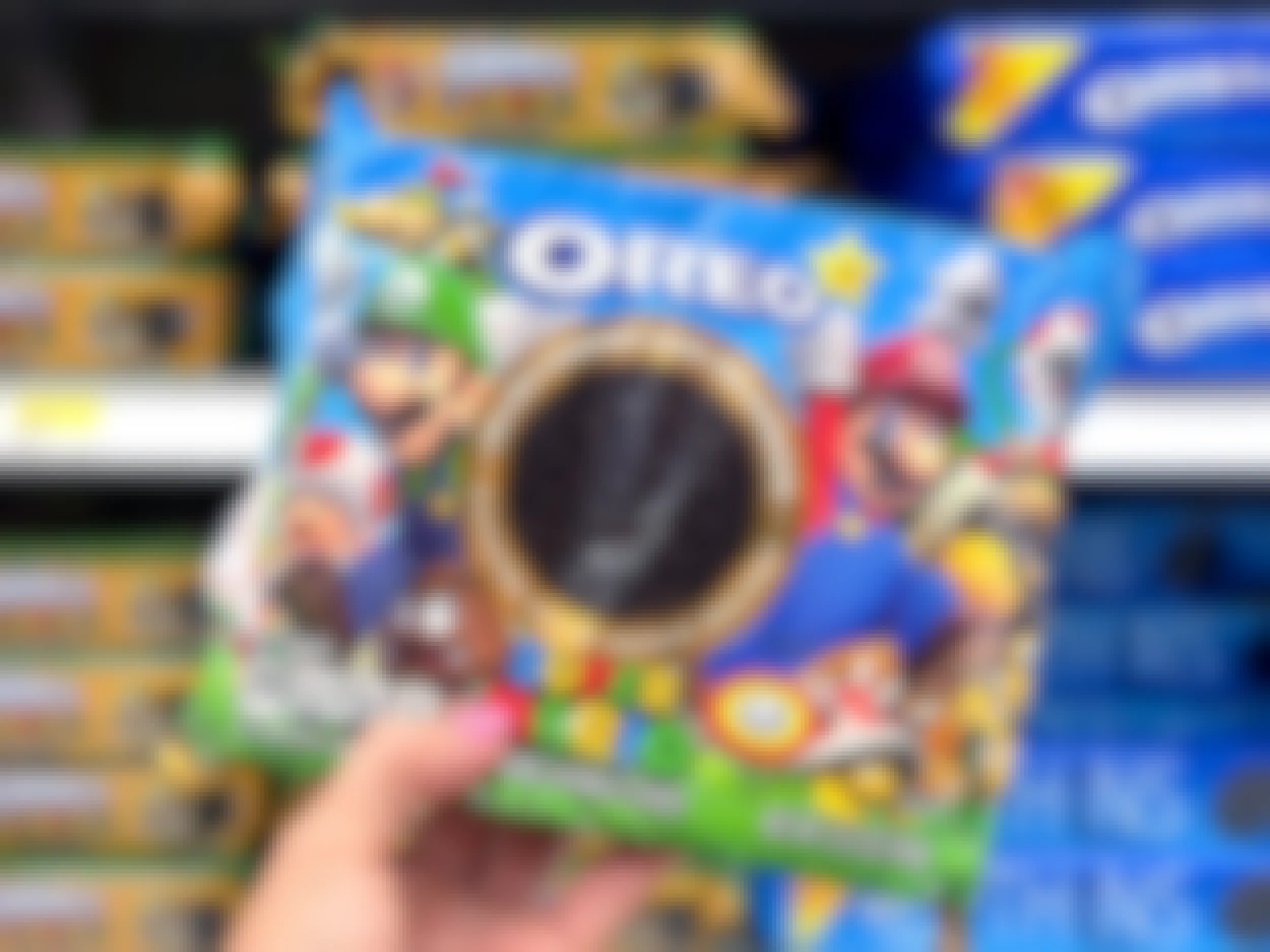 person's hand holding a package of super mario brothers oreo cookies in target store