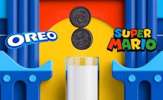 Super Mario Bros Oreo character cookies above a glass of milk with the Oreo and Super Mario logos
