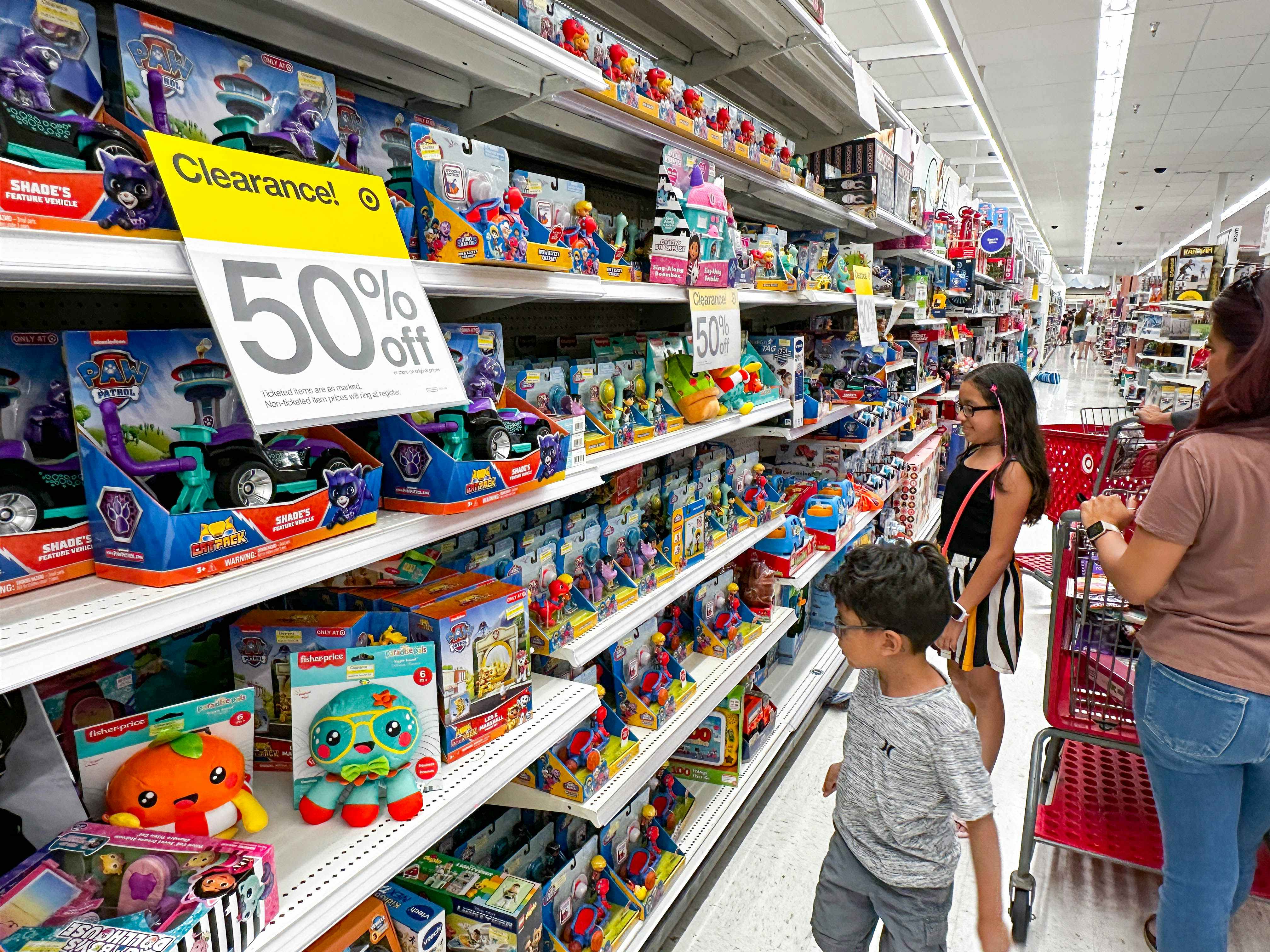 a mother and two kids shopping target toy clearance aisles
