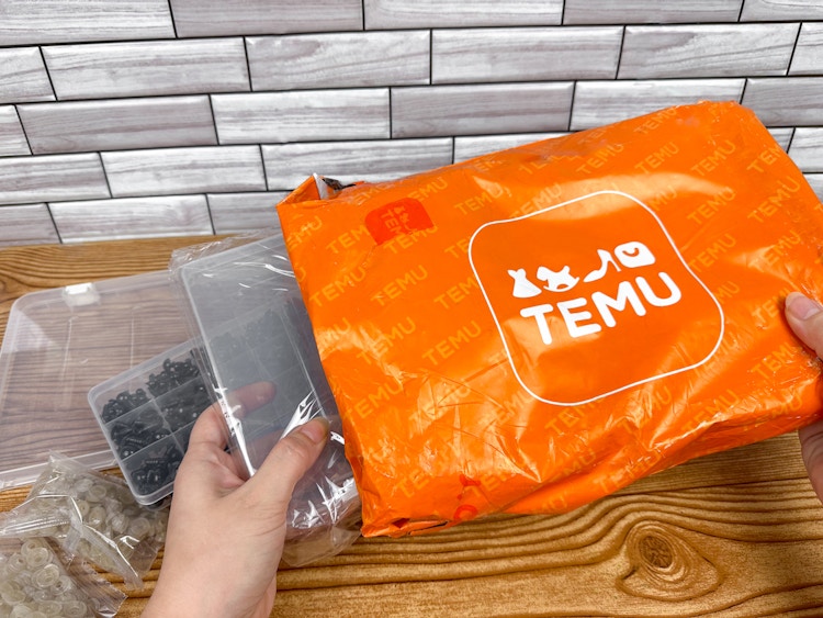 Someone taking their order out of a Temu package