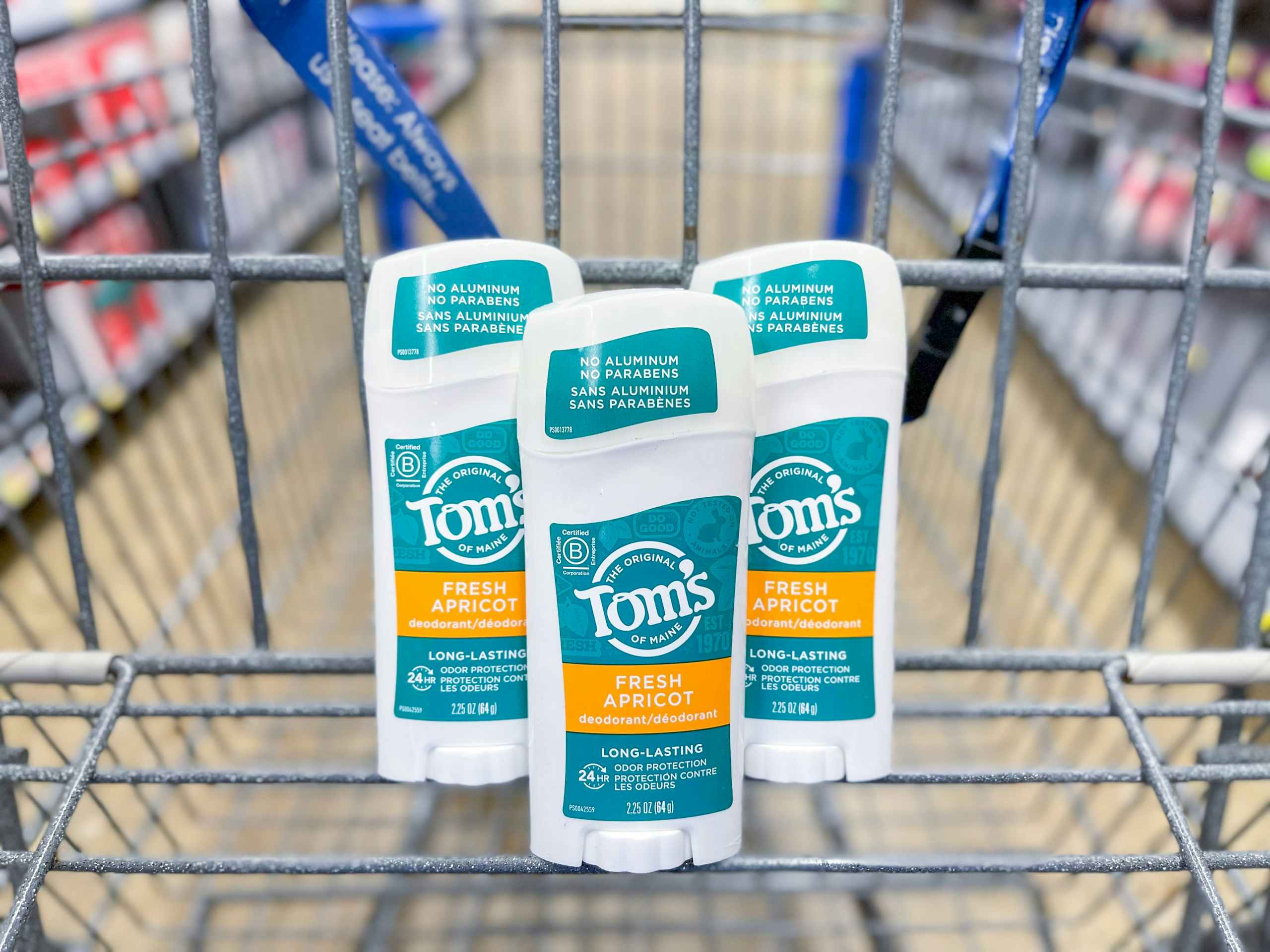 Several Tom's Fresh apricot deodorants sitting in a store cart