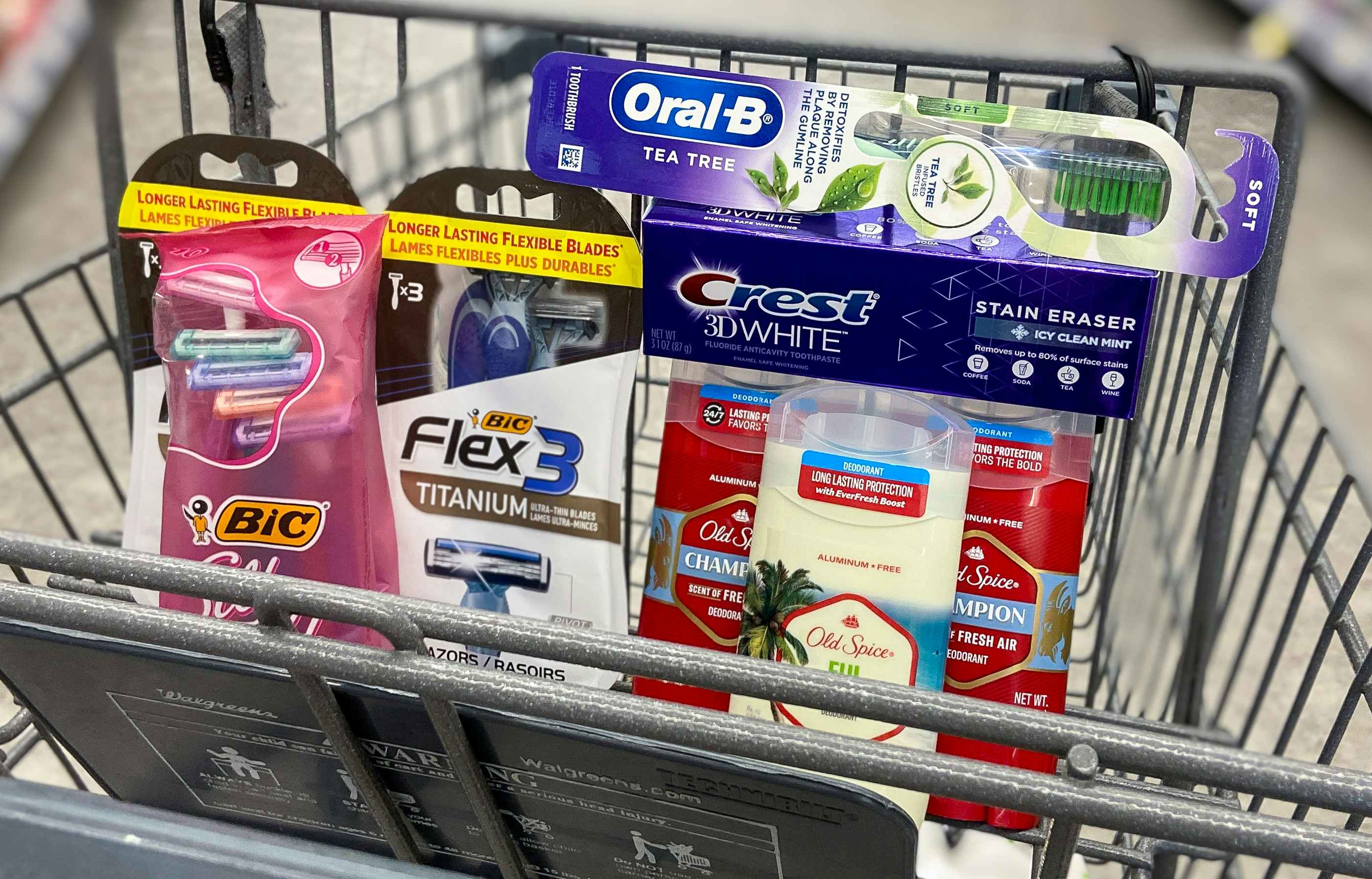 a walgreens cart with bic disposable razors, old spice deodorant, crest toothpaste, and an oral-b toothbrush