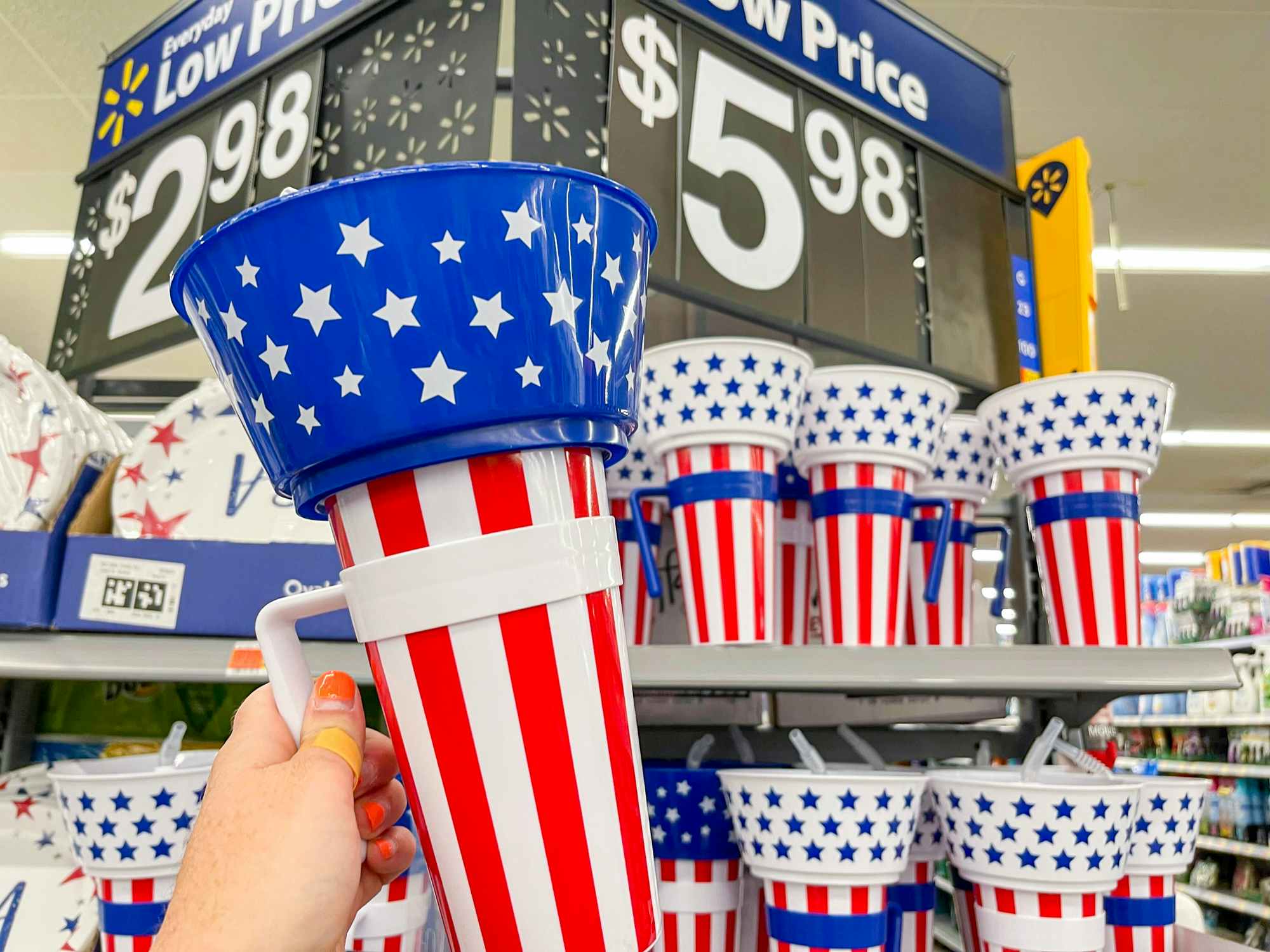 a hand holding up a fourth of july cup in walmart