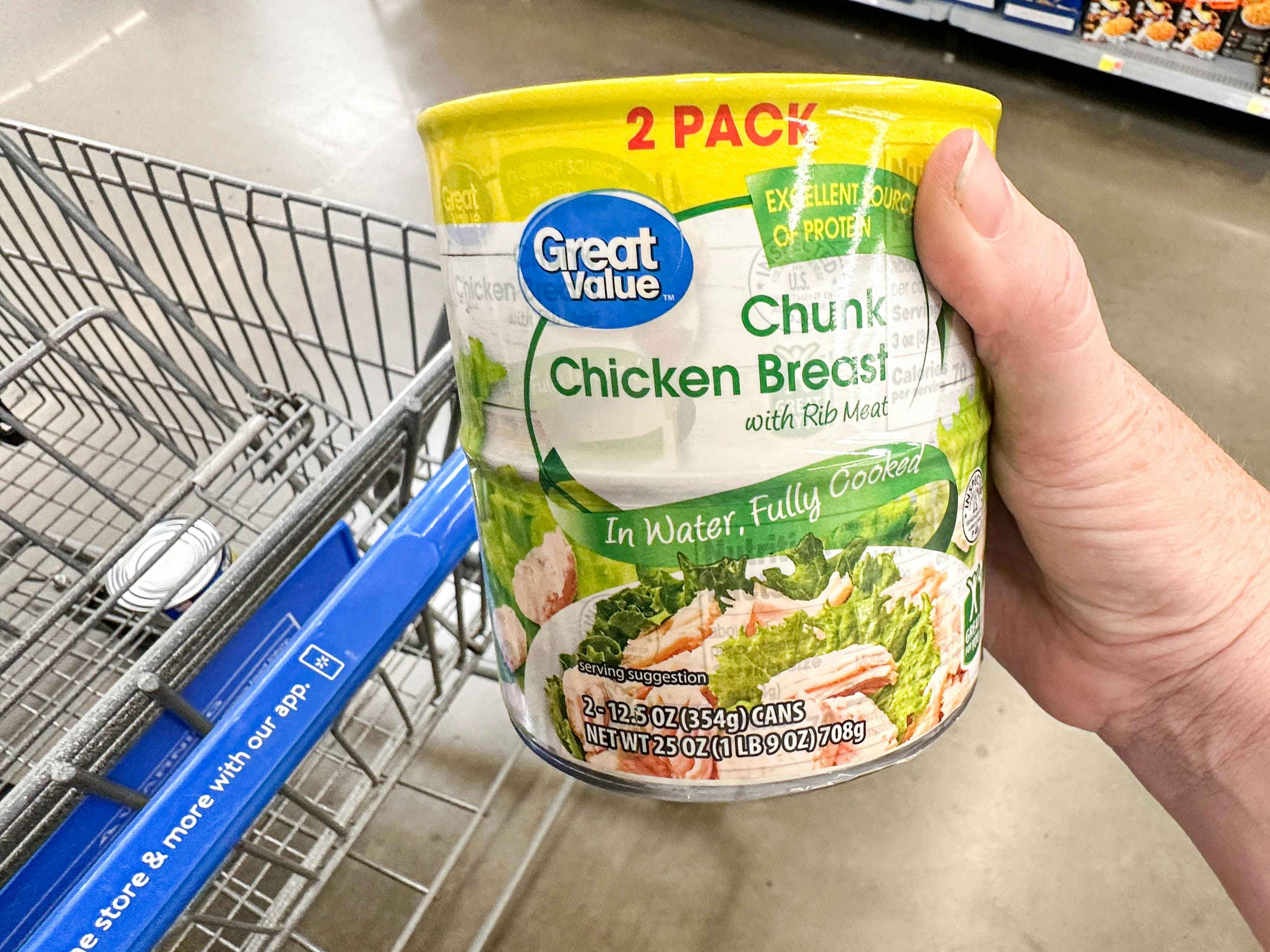 a package of canned chicken breast being held in store 