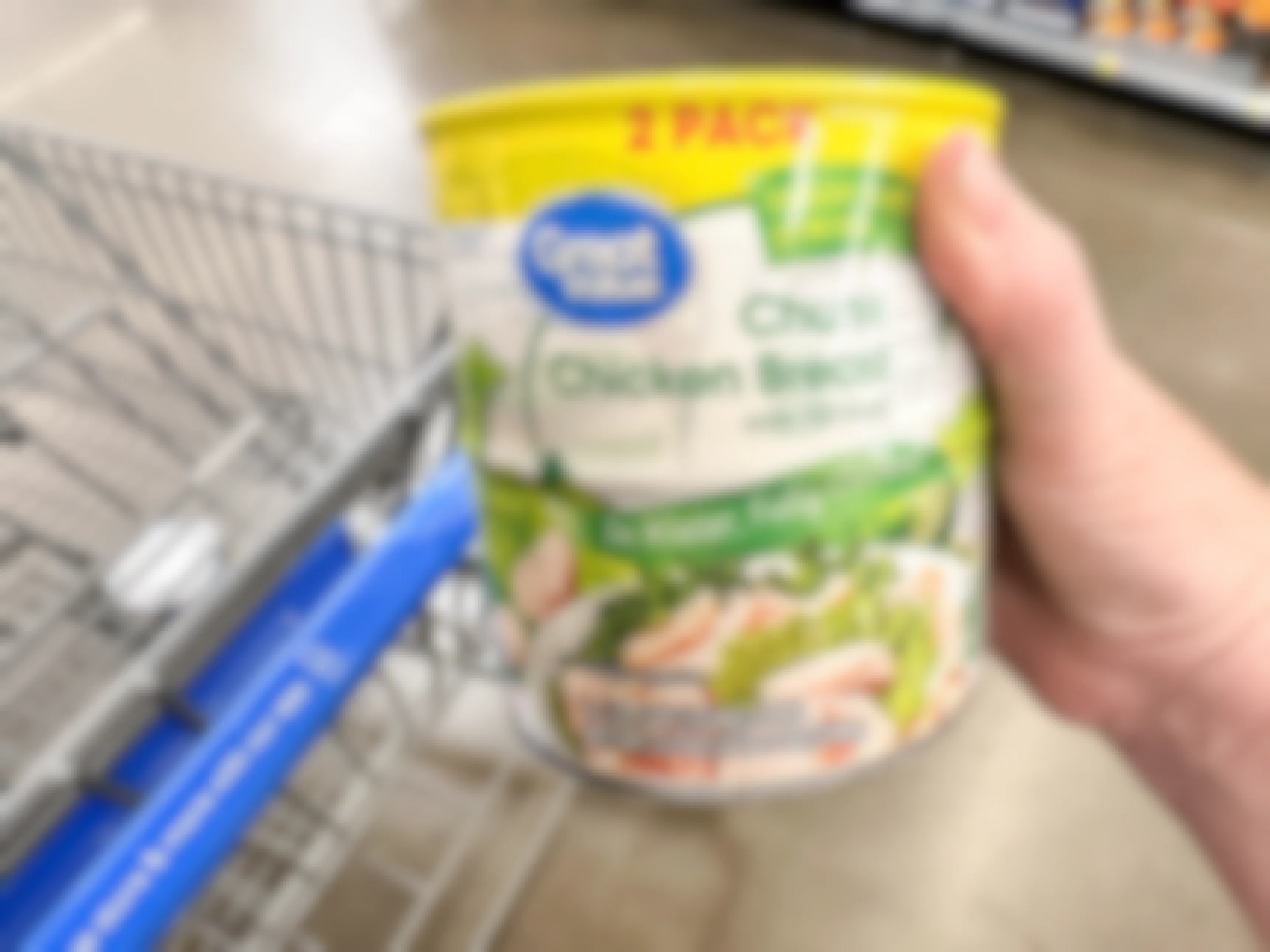a package of canned chicken breast being held in store 
