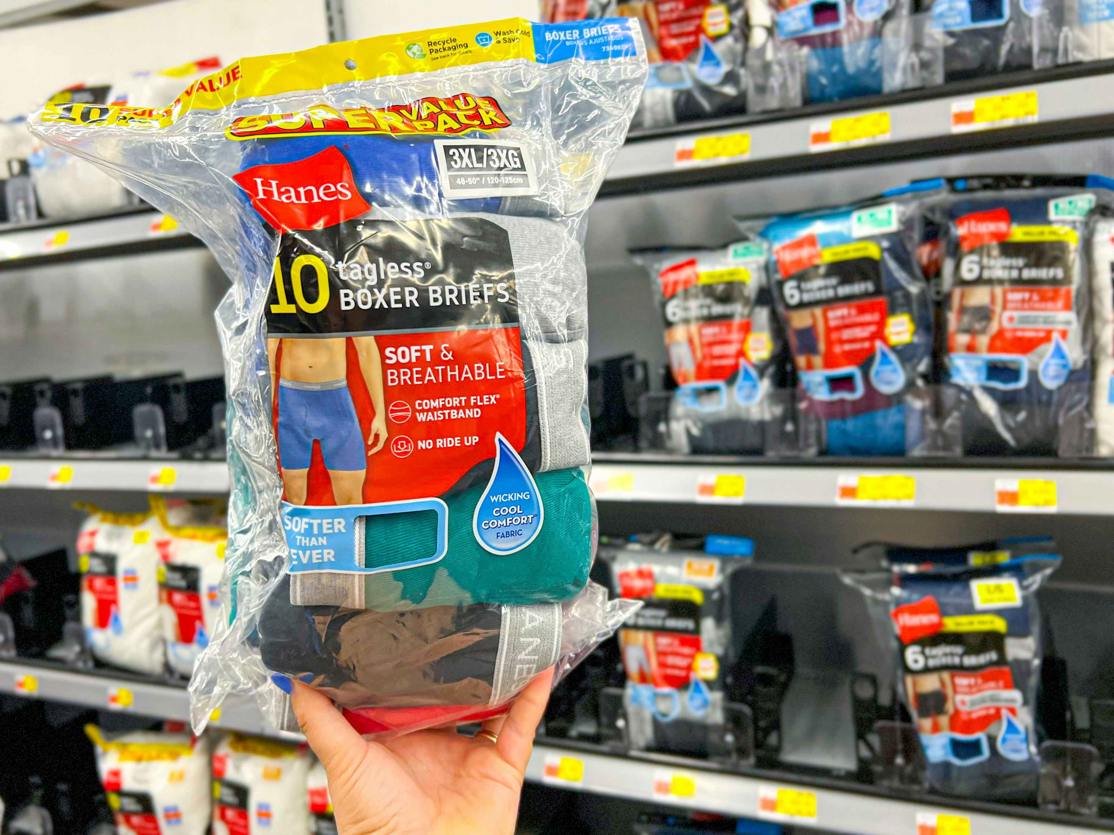 hand holding a super value pack of hanes tagless boxer briefs in walmart aisle