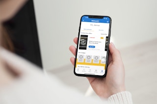 A woman on her smartphone looking at limited-time offers on her Walmart plus account