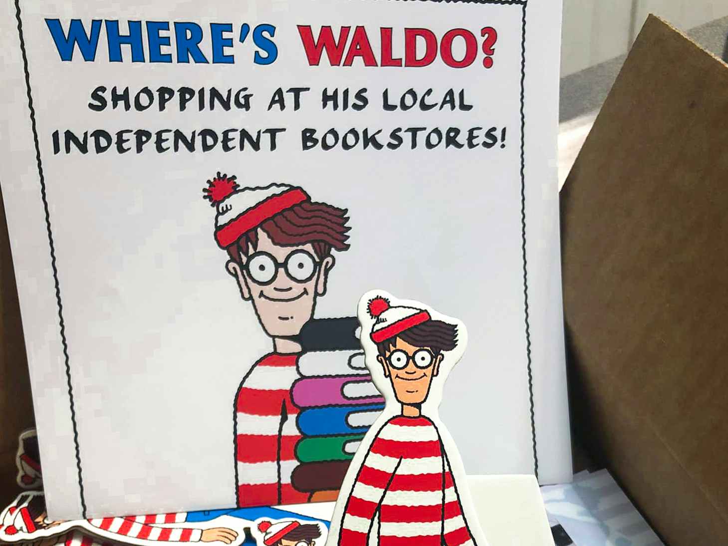 A Where's Waldo sign next to a Waldo standee
