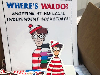 A Where's Waldo sign next to a Waldo standee