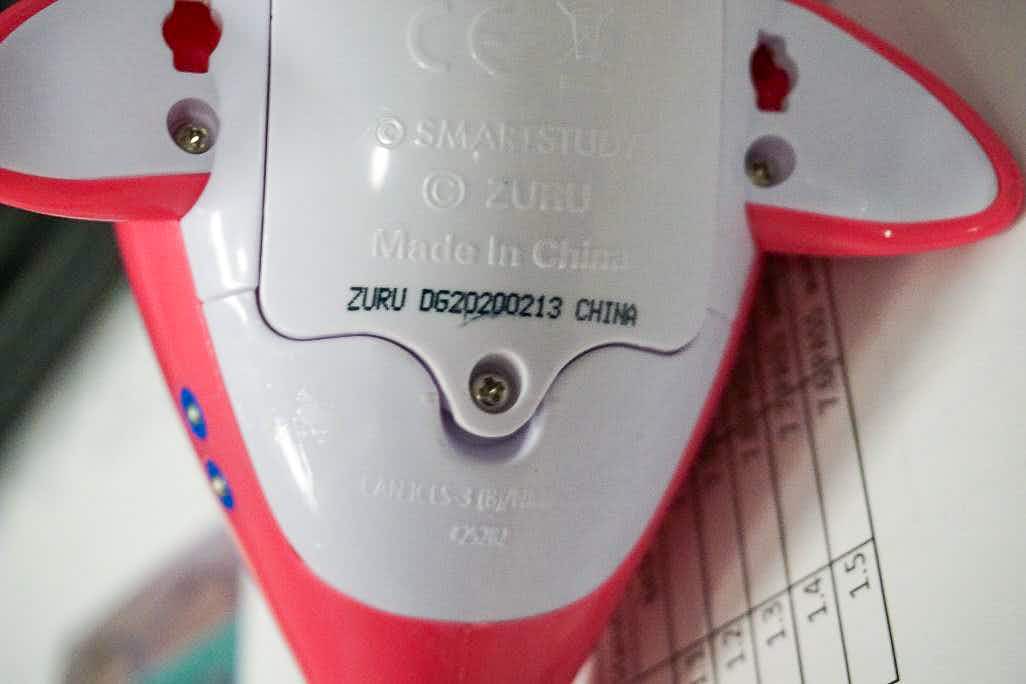 A recalled Baby Shark bath toy showing the code on the bottom