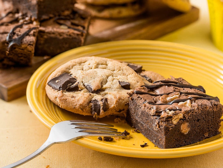 cookie and brownies sitting on a yellow plate