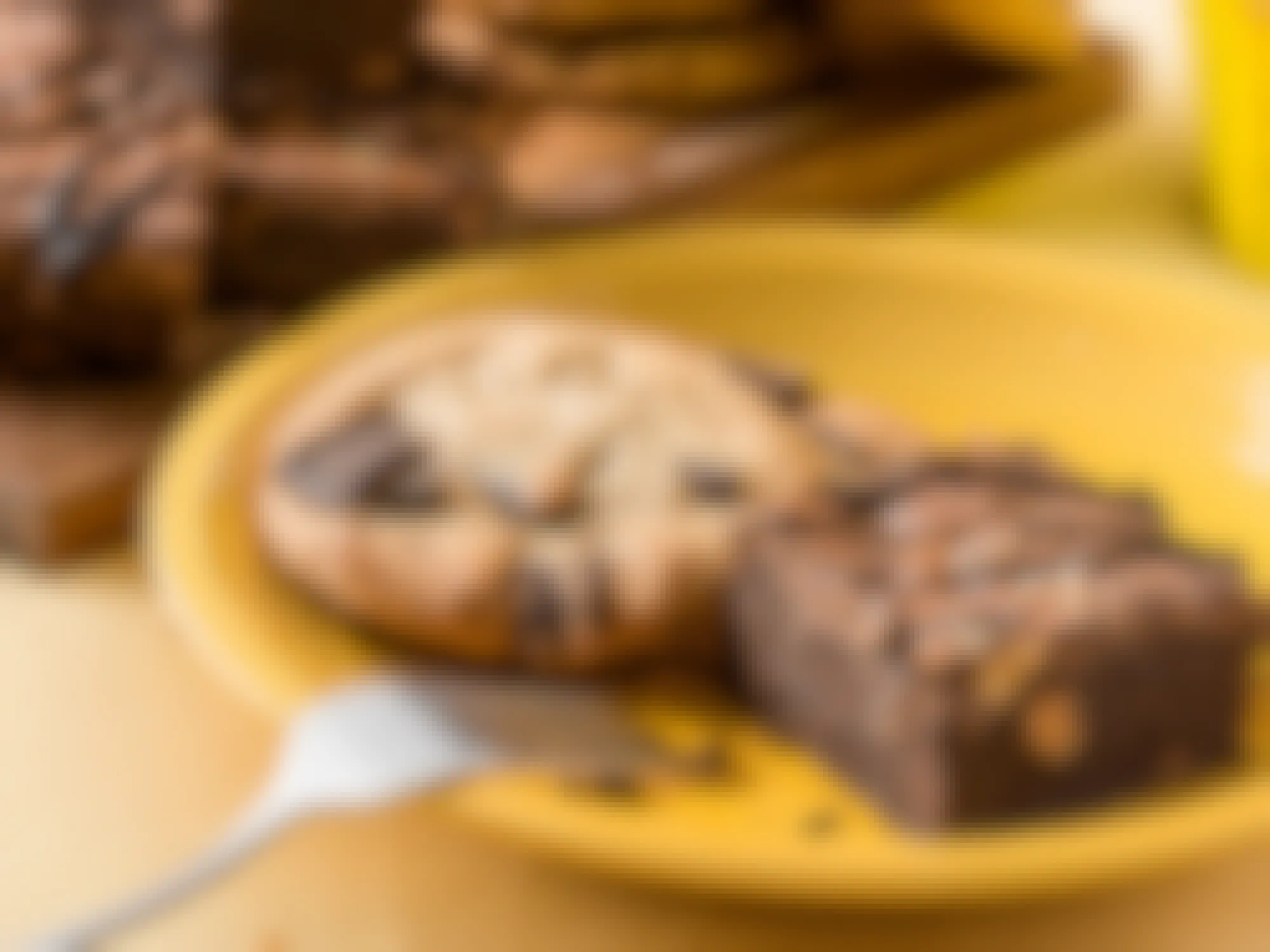 cookie and brownies sitting on a yellow plate