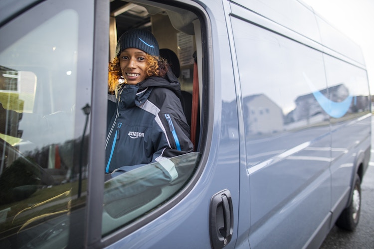 An Amazon employee driving a Prime van