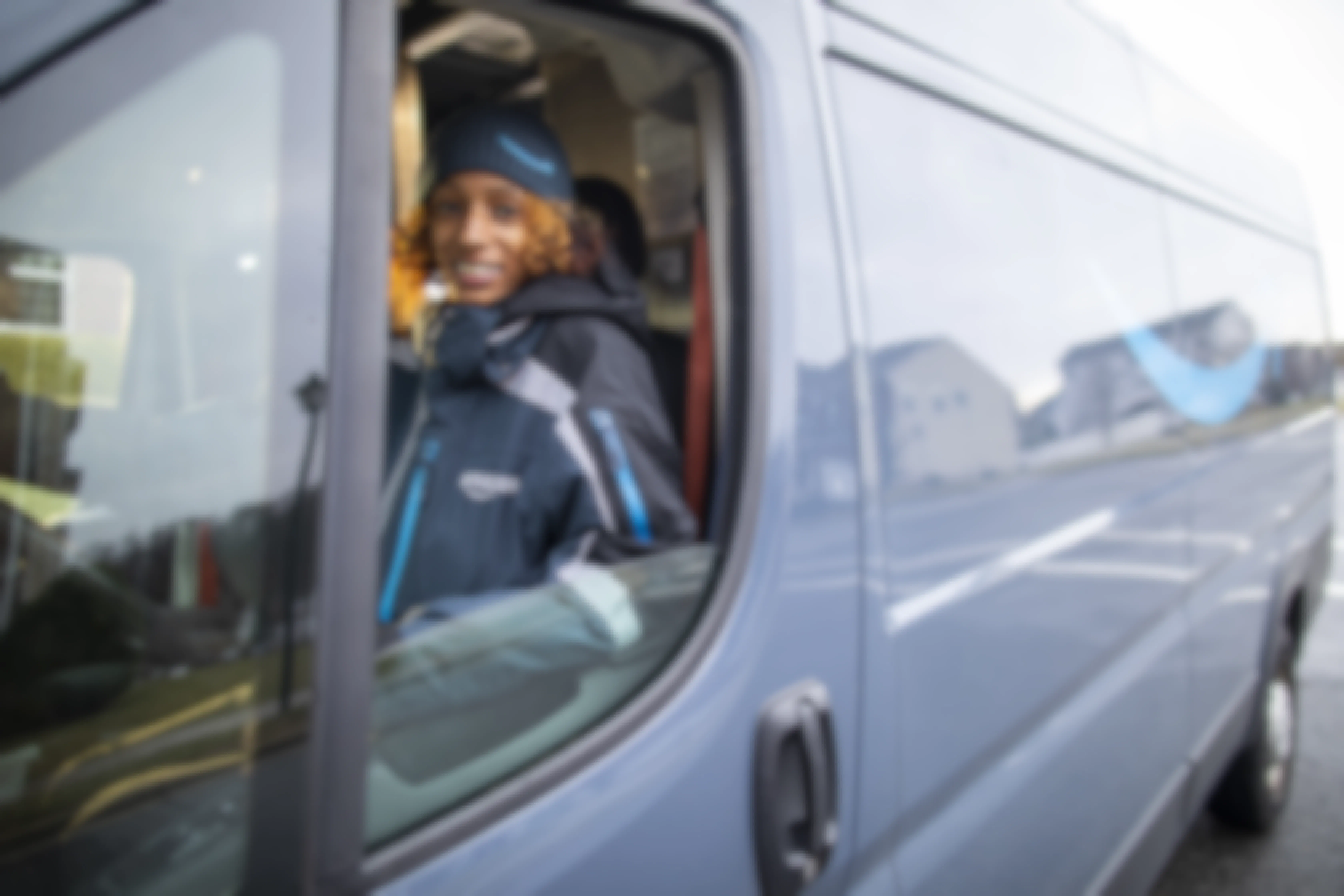 An Amazon employee driving a Prime van