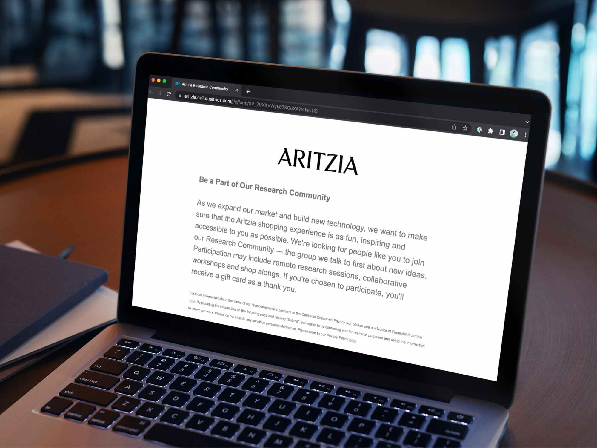 A laptop displaying the webpage about the Aritzia research 