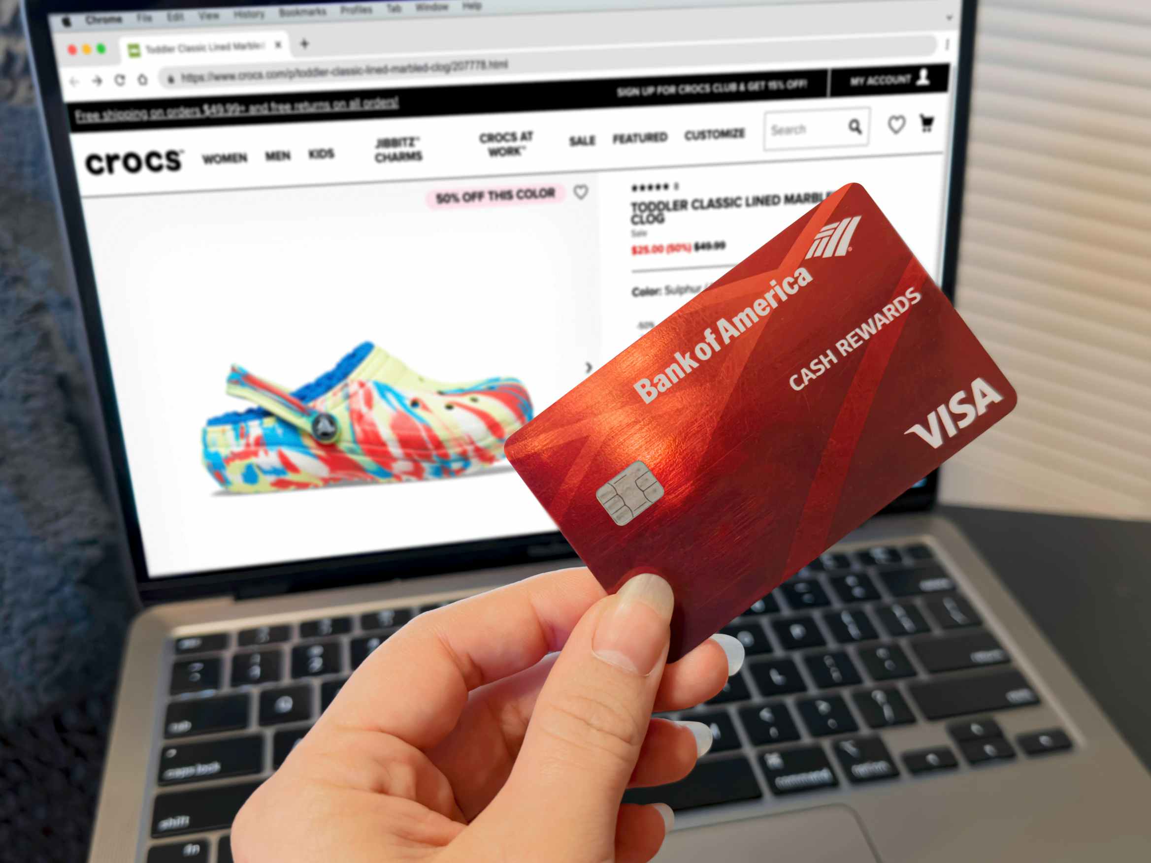 person shopping on crocs.com websitte with bank of america rewards card