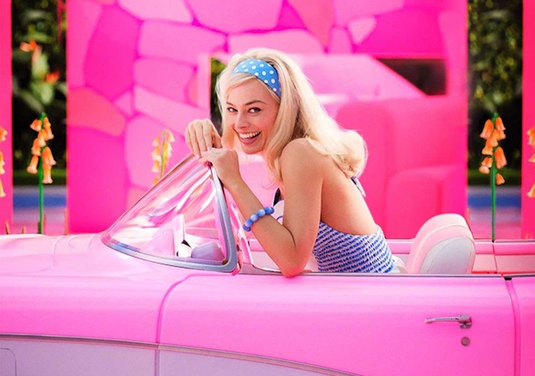 Barbie in a convertible, a shot from the Barbie Movie