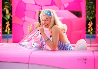 Barbie in a convertible, a shot from the Barbie Movie