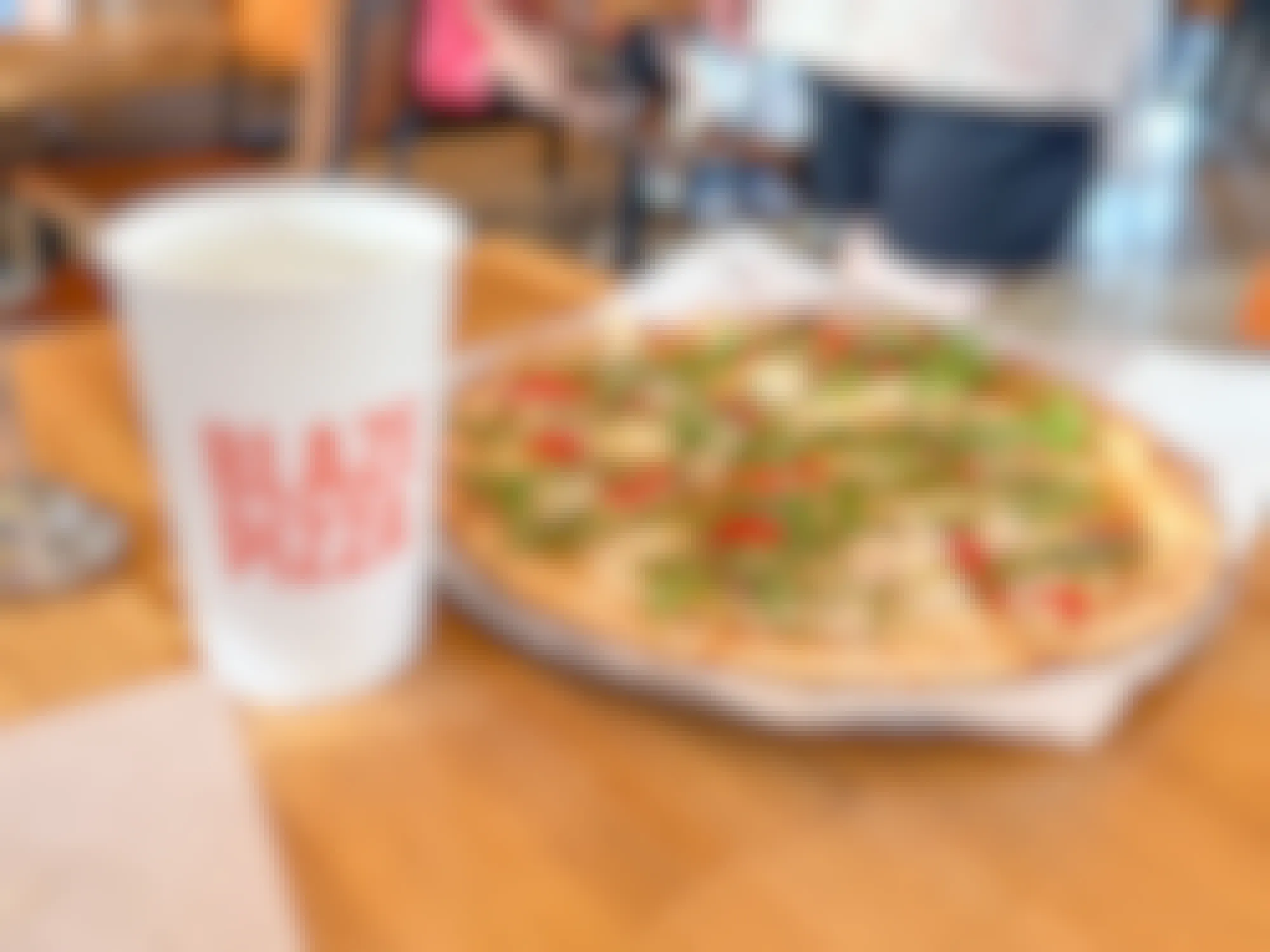 a pizza and drink on a table at Blaze Pizza