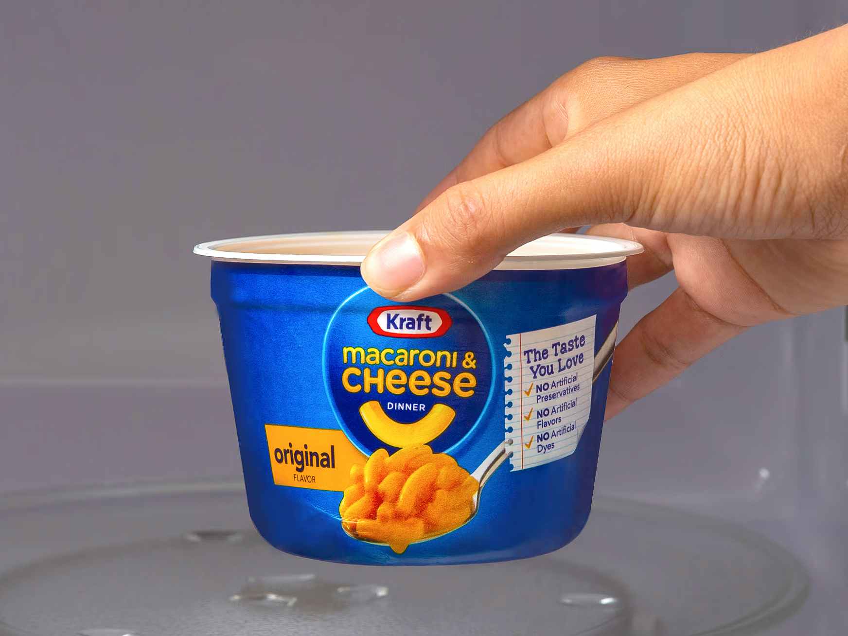 person placing a kraft mac and cheese single-serve pouch in microwave