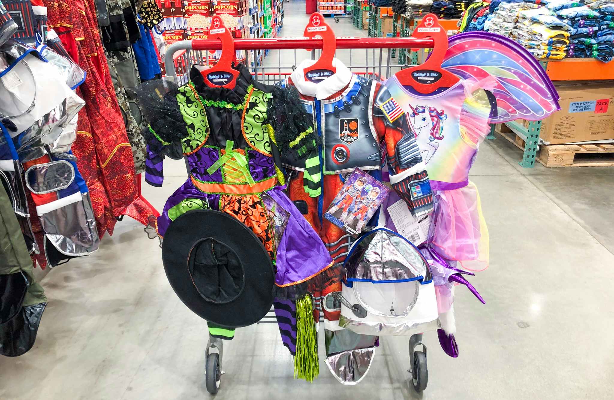 Children's Halloween costumes hanging on a Costco cart